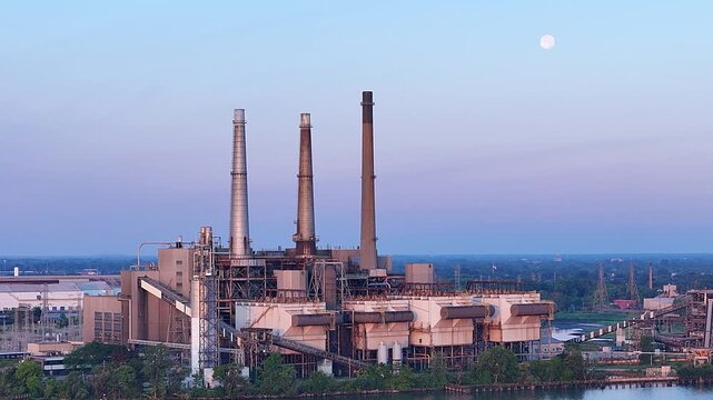 DTE River Rouge Power Plant with moon above during early evening in Michigan, USA