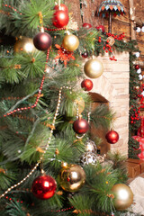 Christmas decorated fireplace with green garland and red berries for a festive holiday interior