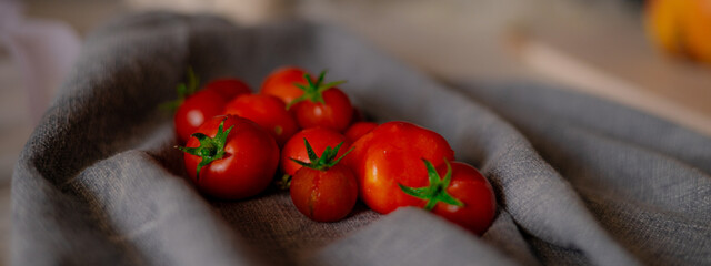 Red tomatoes on grey kitchen towel