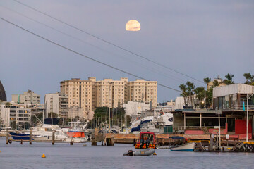 view of the moonrise in the urca neighborhood in rio de janeiro.