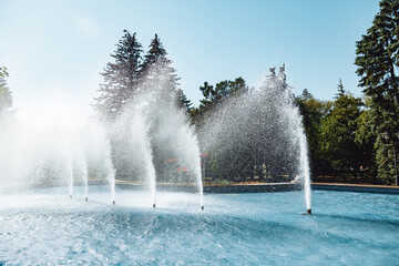 city fountain in the center of Stavropol with a rainbow on the water jets. Sunny day, freshness and...