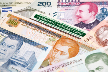 Fototapeta premium American Permanent Resident Card on Honduran Lempira