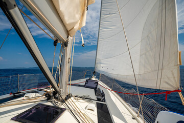 Sailing yacht moving at full speed with all sails up in the open sea near Croatia. Dynamic maritime...