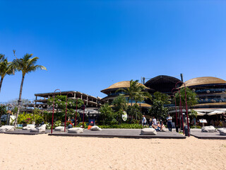 Bali Indonesia august 7,2025 : A modern, open-air shopping mall sits on the coastline, offering visitors a blend of retail, dining, and scenic ocean views on a sunny day.