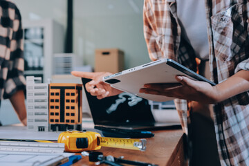 Construction and structure concept of engineer working drawing on blueprint meeting for project...