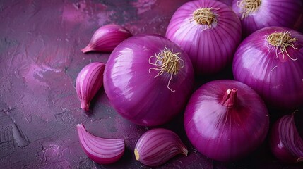 Fresh Red Onions and Sliced Pieces on a Textured Purple Surface