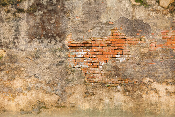 Weathered palace wall with exposed brickwork in Hue Imperial City Vietnam