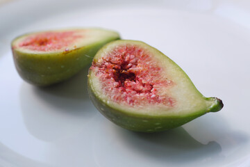 Sliced figs on a white plate. Close-up of delicious fruit.