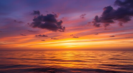 Fototapeta premium Stunning vibrant sunset over calm ocean waters with dramatic clouds painting the sky