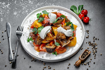 Veggie salad with creamy dressing. Fresh and vibrant salad featuring tomatoes, peppers, and herbs topped with a creamy dressing and spices.