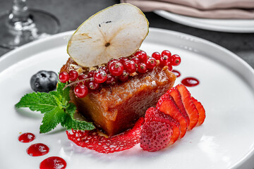 Yummy dessert with fresh fruit. A gourmet dessert features a sweet slice with assorted fruit,...