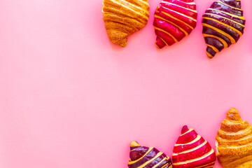 Obraz premium Croissants on pink table top view.