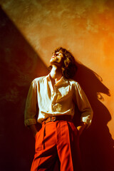 Fototapeta premium A woman in a white shirt and red pants is standing in front of a wall