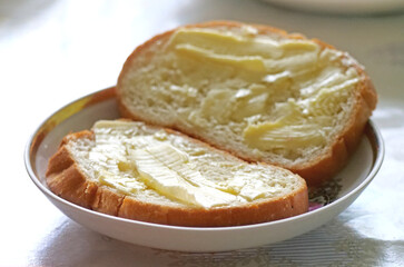Bread and butter close-up - Simple breakfast toast - Close-Up of Butter Melting on Two Slices of Fresh White Bread