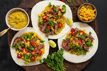 Mexican tacos with beef, tomatoes, vegetables, chilli and onions