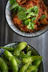 two asian dishes is edamame and Kim chi.