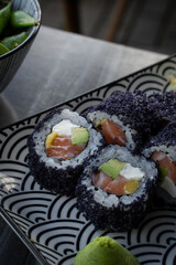 sushi with salmon, mango and black sesame. 