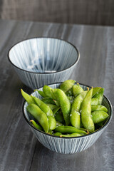 Plate with hot green edamame with salt.
