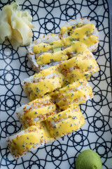 sushi with yellow sauce on top.