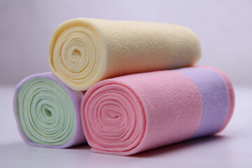 soft cotton candy in roll shape, smooth texture, pastel colors, white background