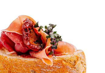 Gourmet sandwich with prosciutto and sun-dried tomatoes at a modern café