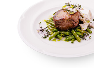 Elegant dish featuring tender meat served with green vegetables