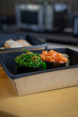 two Gunkan sushi with seaweed and with salmon.