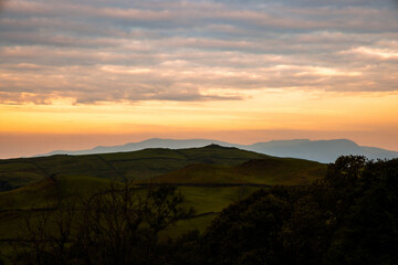 Hilltop Cairn of rocks silhouetted by sunset evening sky, Latterbarrow, The Lake District, Cumbria, England