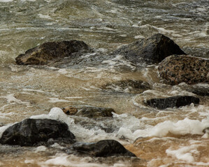 A rocky shoreline with a body of water