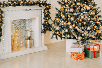 Decorated fireplace mantel with garlands and ornaments next to Christmas tree with presents. Festive interior decor for new year celebration.
