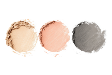Three circular makeup samples, light beige, peach, and grey.  Each sample has a slightly irregular, smudged appearance