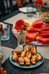 Fresh and vibrant summer spread with fruits and bite-sized appetizers.