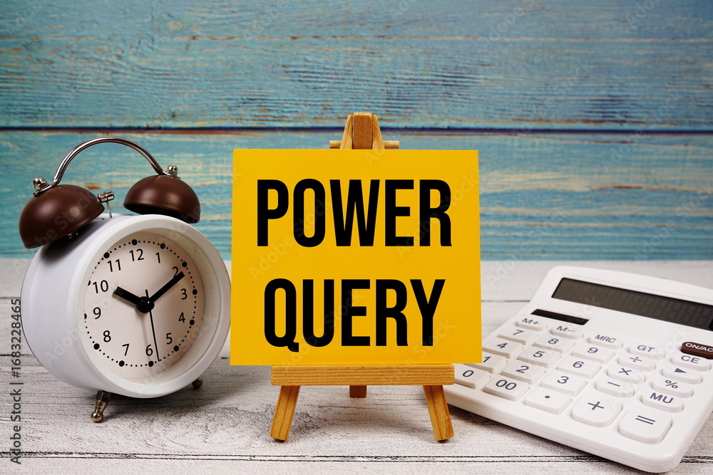 Poster power query text written on paper card with calculator and alarm clock on wooden background