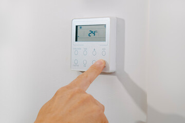 man turning on or off the air conditioning