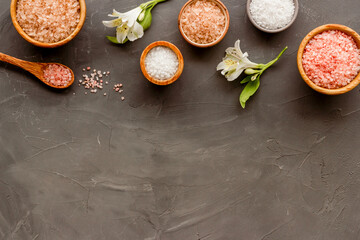 Spa treatment body care cosmetics - sea salt and scrubs in bowls, top view