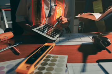 Closeup of team of industrial engineers meeting analyze machinery blueprints consult project on table in manufacturing factory. Working in manufacturing plant or production plant.