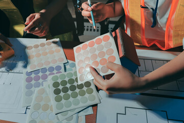 Closeup of team of industrial engineers meeting analyze machinery blueprints consult project on table in manufacturing factory. Working in manufacturing plant or production plant.