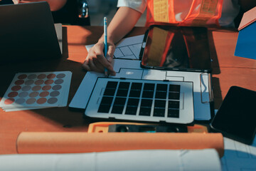 Closeup of team of industrial engineers meeting analyze machinery blueprints consult project on table in manufacturing factory. Working in manufacturing plant or production plant.