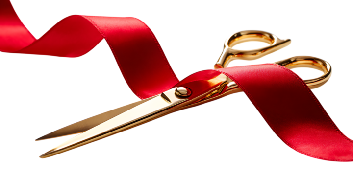 Golden scissors cutting a red ribbon, symbolizing a grand opening or inauguration.