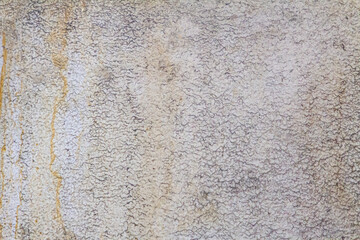 Close-up of weathered wall showing detailed texture and discoloration.