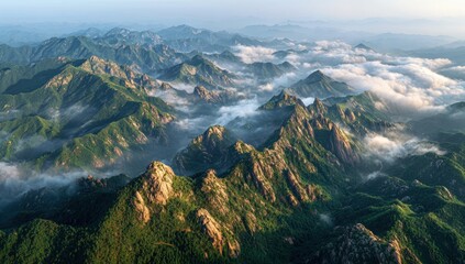 Majestic mountain range shrouded in morning mist