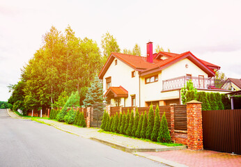 Villa at seaside.Street of beautiful houses in suburban. Landscaping for suburb home. Spruce, pine...