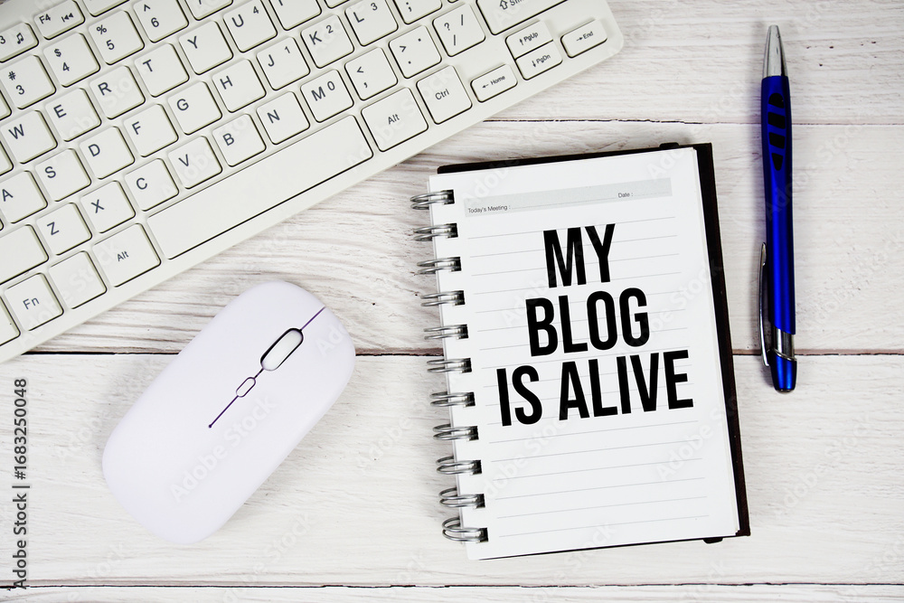 Poster my blog is alive text with keyboard and wireless mouse on wooden background