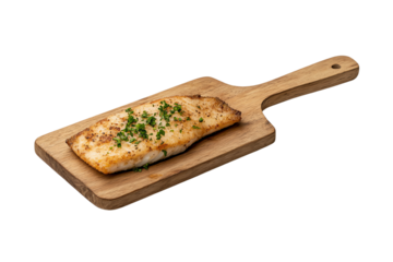 Delicious grilled fish fillet topped with herbs on a wooden cutting board.