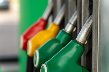 Close-up of four fuel dispensing nozzles on a gas pump