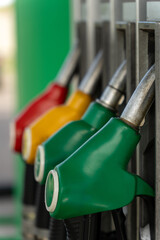 Close-up of four fuel dispensing nozzles on a gas pump