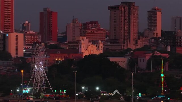 cityscape view featuring Ecko Park and Metropolitan Cathedral in front of Asuncion skyline at sunset