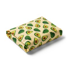 Folded fabric with avocado fruit pattern on beige background