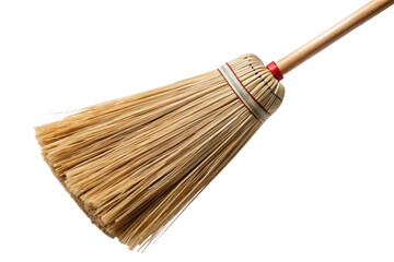 Close-up view of a rustic straw-bristled broom with a patterned handle isolated on a black background transparent background