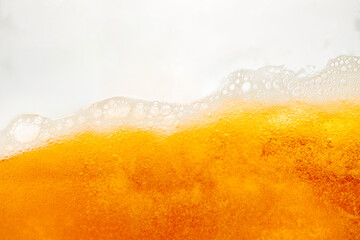 Close up bright orange Oil or beer splash texture and nature waves, Beautiful waves curve and little bubbles smooth for graphic design and background, Oil Bubbles, Soft beer bubbles, Selective focus